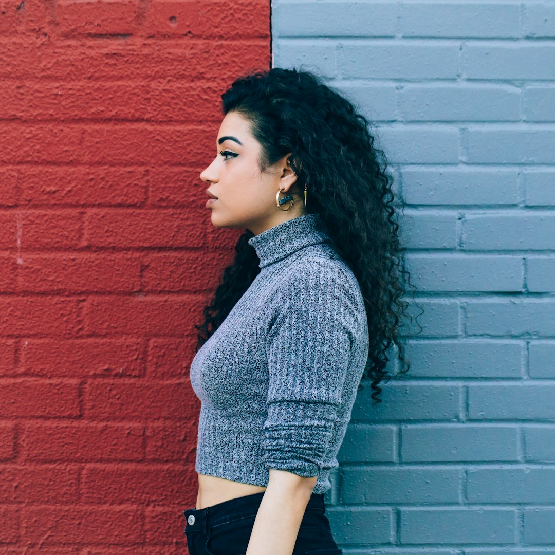 woman standing in the middle on red and gray painted wall