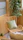 A calm setting with a cozy chair and plants, evoking peace and mindfulness in a natural green palette.