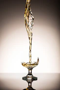 Elegant swirl of golden liquid suspended in crystal glass.