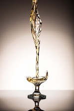 liquid pouring on clear short-stem wine glass