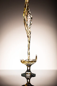 Elegant swirl of golden liquid suspended in crystal glass.