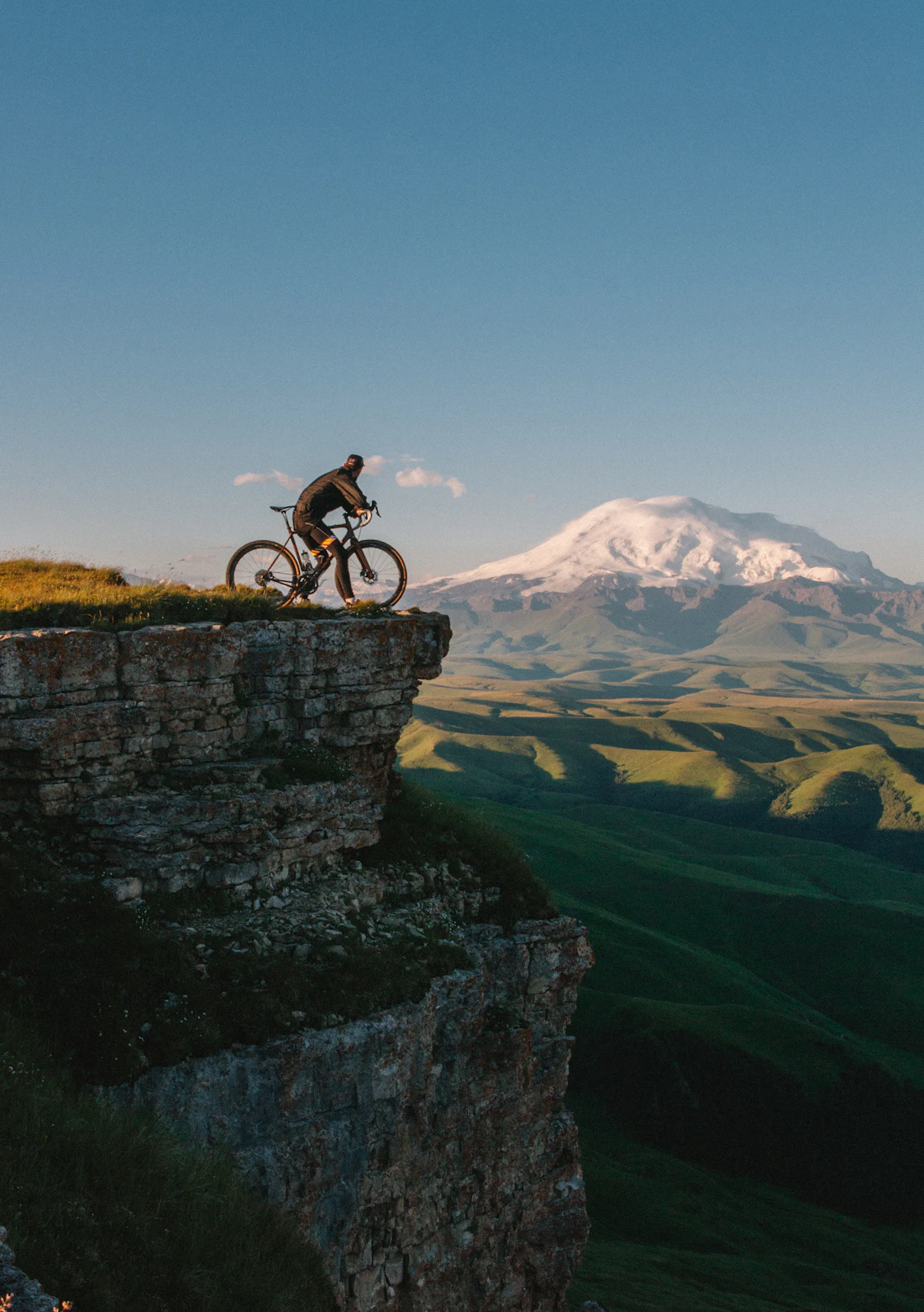 Riders on a mountain road at sunset