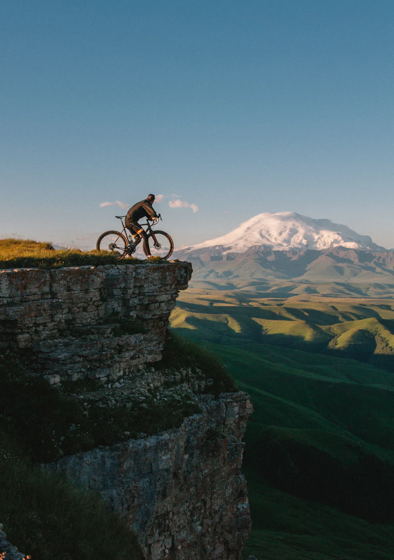 Riders on a mountain road at sunset