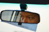 A cinematic close-up of a driver’s focused expression behind the wheel, highlighting genuine interaction.