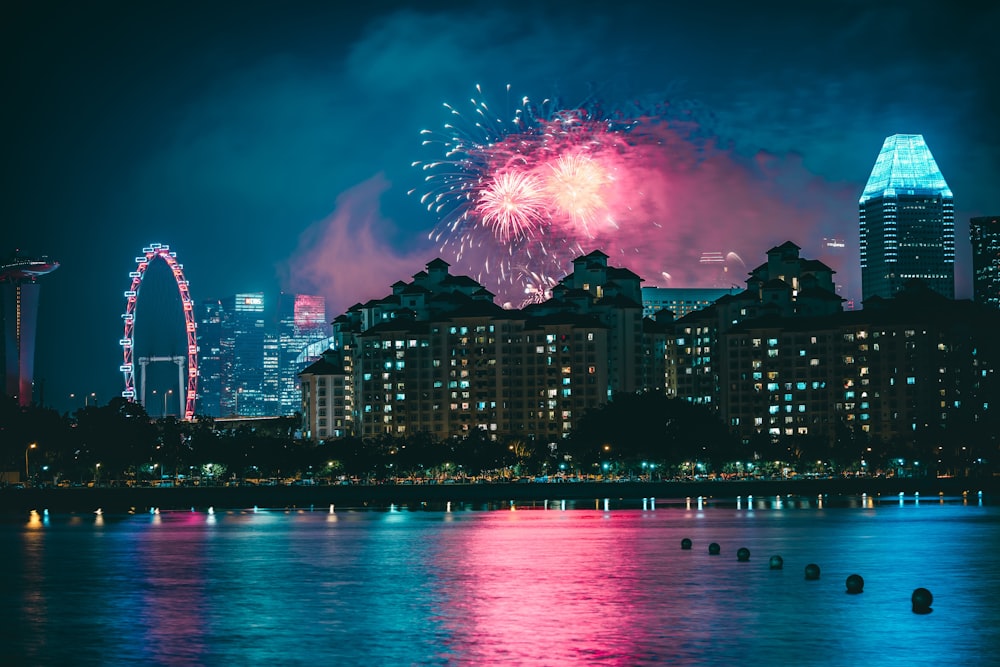 fireworks above high-rise buildings at nighttime