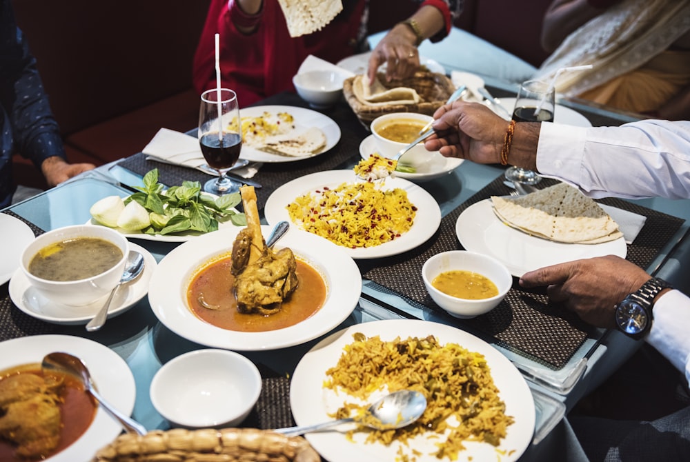 group of person facing table with cooked dishes