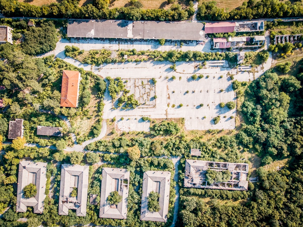 aerial photography of brown gray concrete buildings surrounded by trees