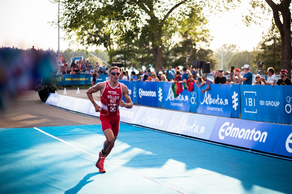 man in red tank top running