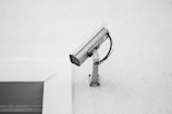 A CCTV IP security camera on white wall