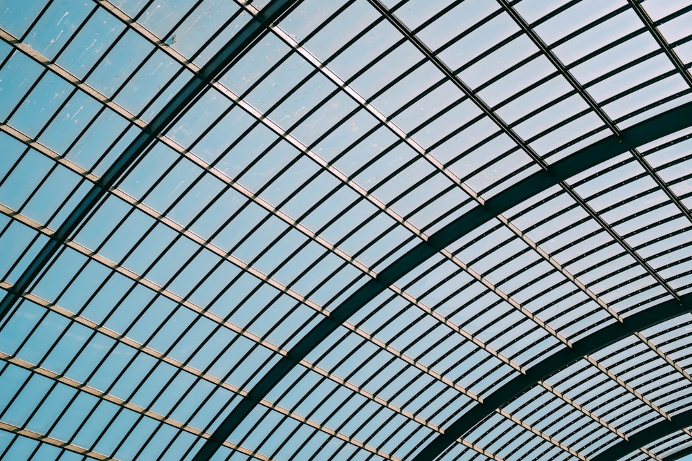 a train traveling through a train station under a blue sky