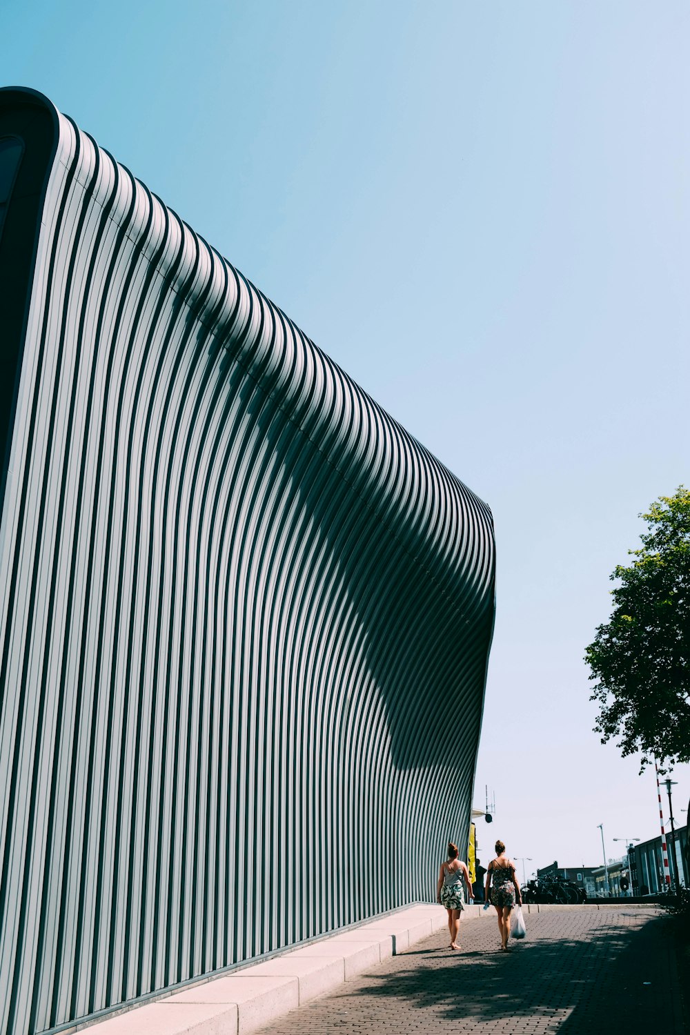 two people walking by architectural structure