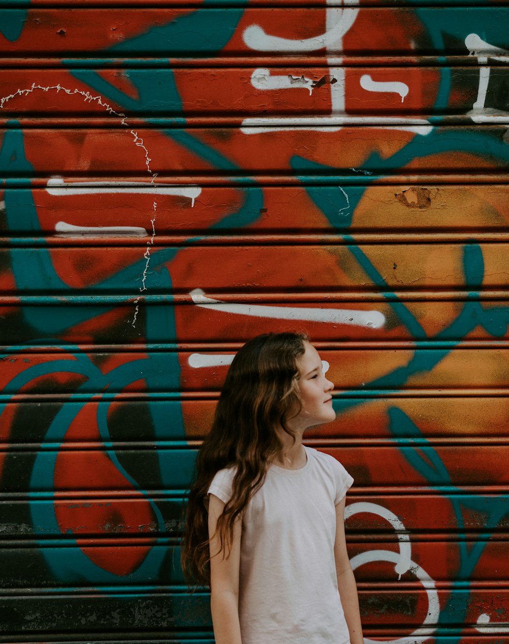 girl near brown, teal, and black roller shutter