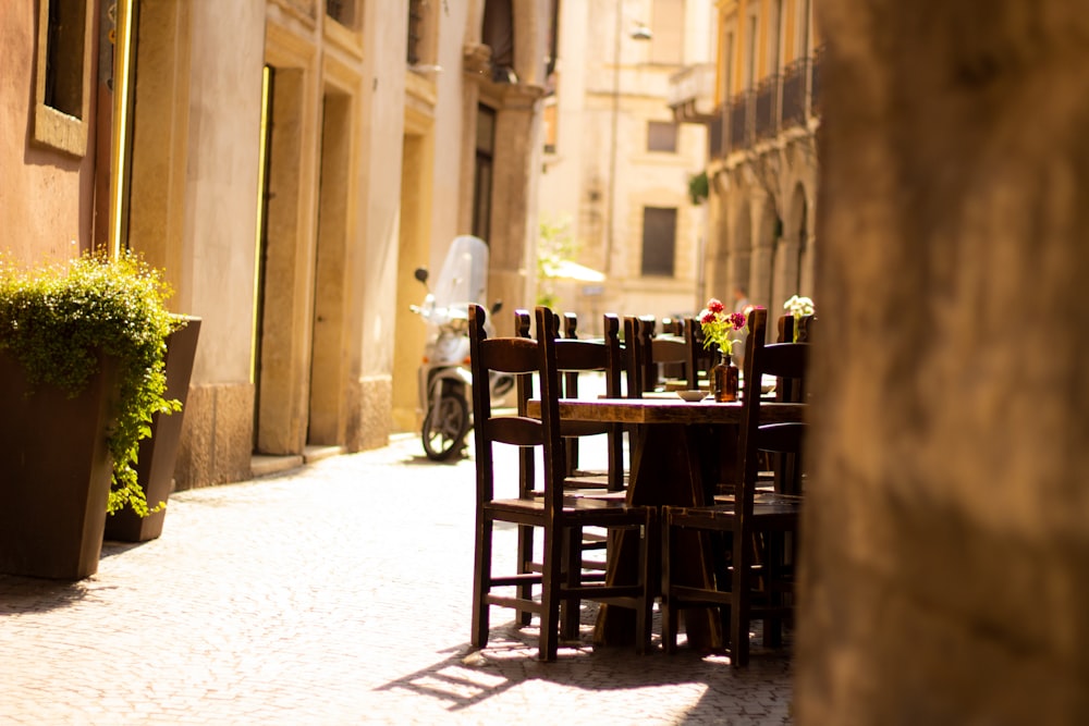 brown wooden dining set on concrete sidewalk