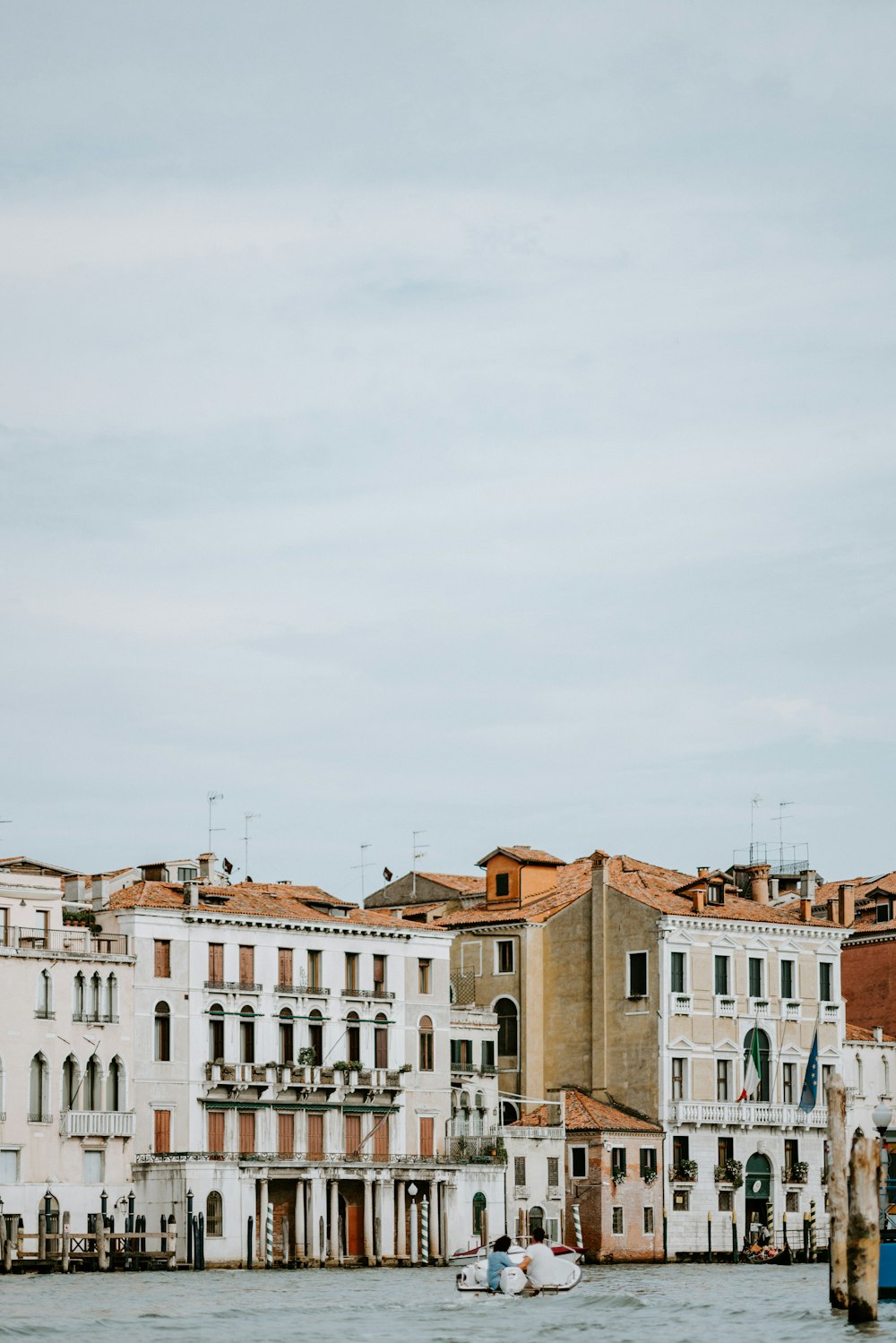 white and brown concrete houses beside body of water