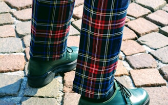 person wearing blue, red, and gray plaid pants