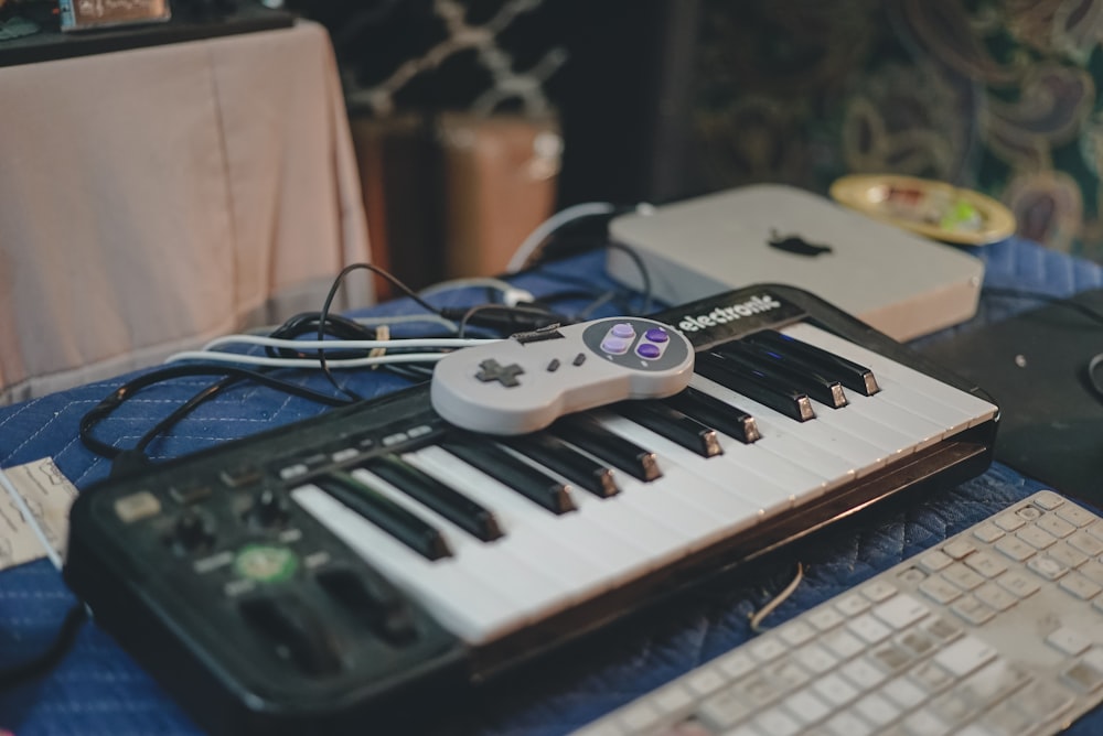 white and black electronic keyboard on blue table