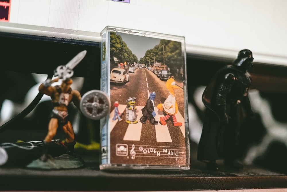 two He-Man and Darth Vader figurines on table