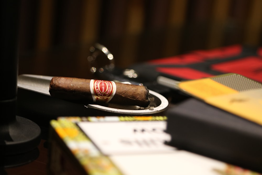 selective focus photography of brown cigar on table