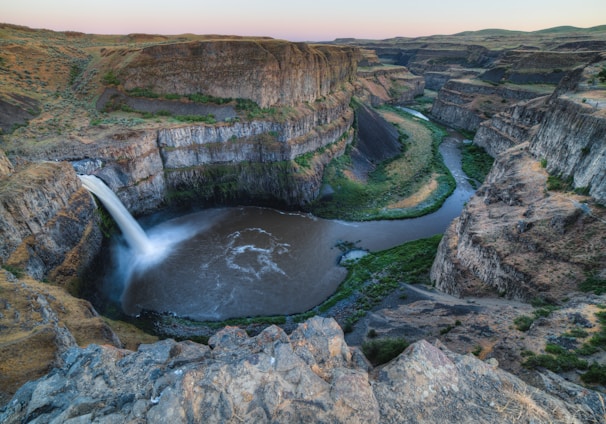 bird eye view photography of waterfalls between cliffs