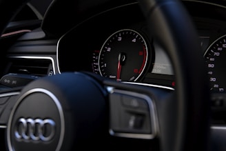 black Audi vehicle steering wheel