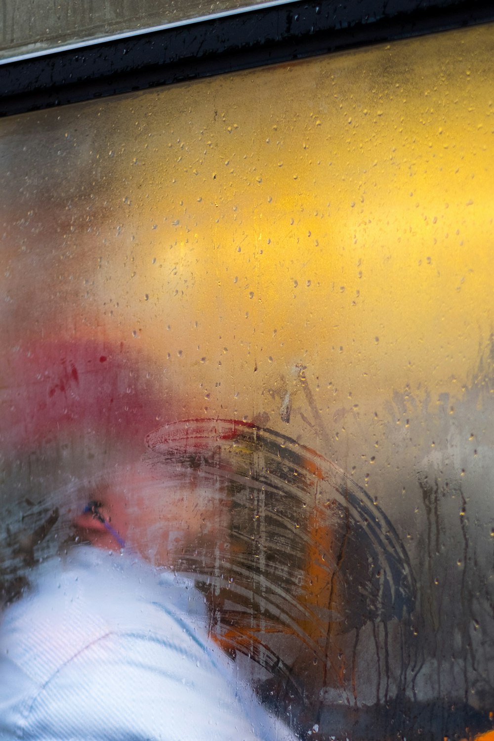 a blurry image of a person sitting in a bus