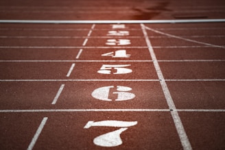 Close-up of a digital race timer displaying finish times at a running event.