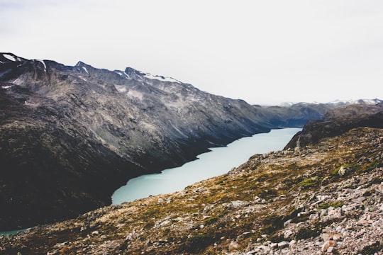 aerial view of body of water surrounded by mountains in Besseggen Norway