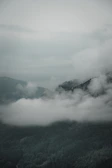 A serene mountain landscape view from the retreat, with mist rolling over the hills.