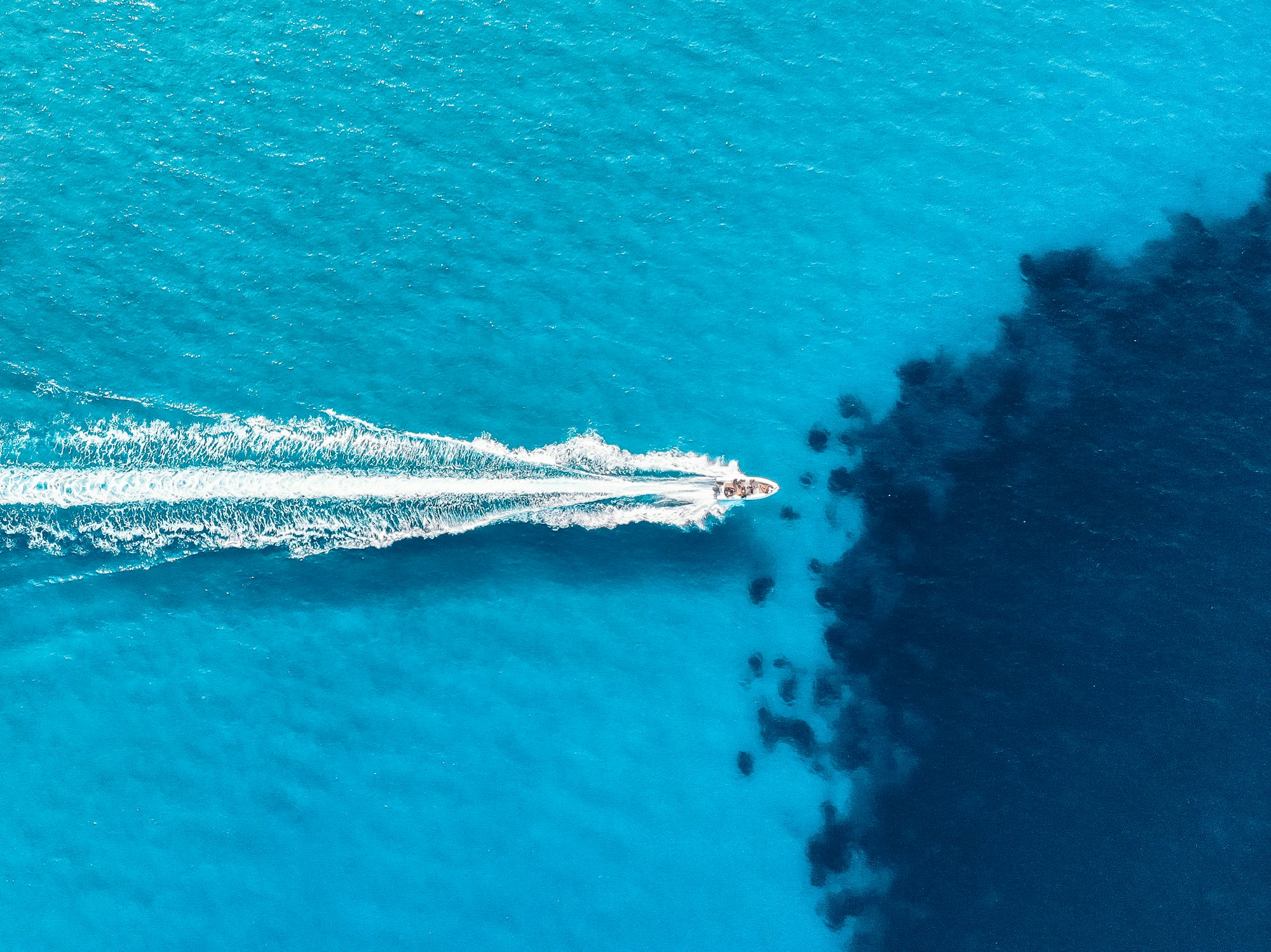 Bird's eye view of a boat in clear blue water