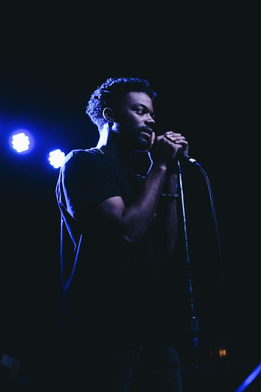 man standing while holding microphone