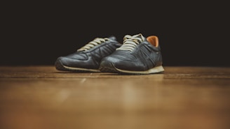 pair of black basketball shoes on table