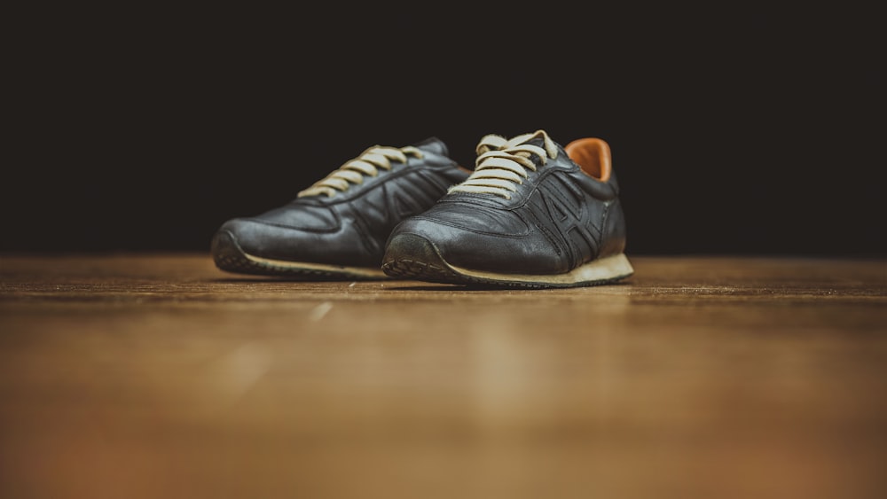 pair of black basketball shoes on table