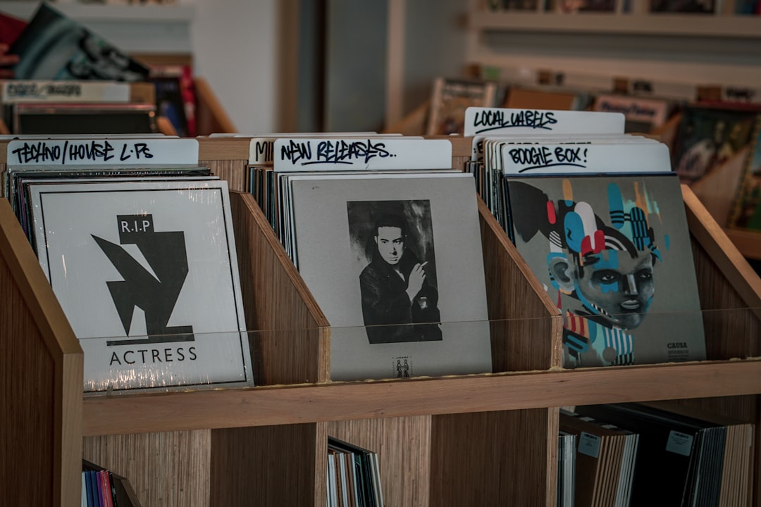 assorted albums on brown wooden rack