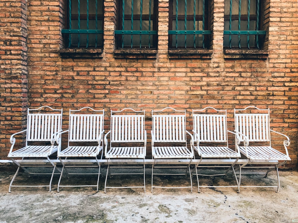 six white steel chairs