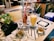 A cozy café table set with a variety of colorful snacks and drinks.