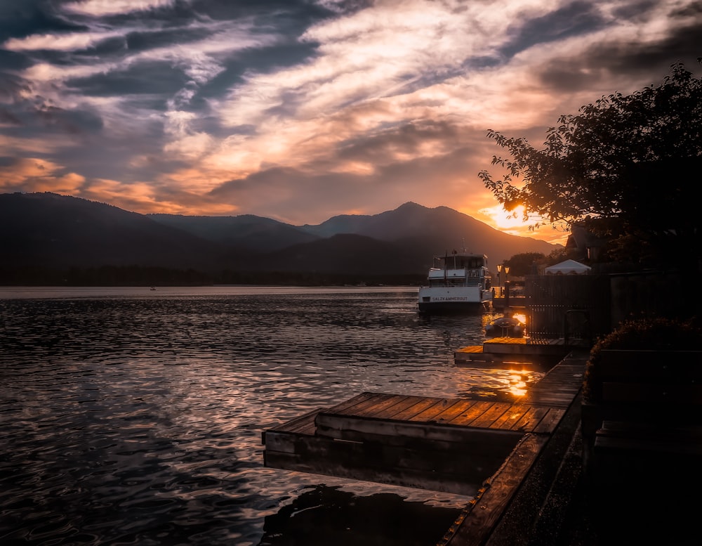 boat on body of water near mountain