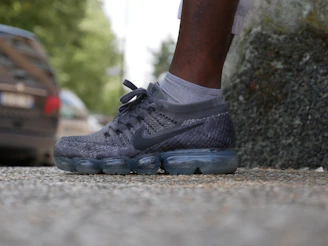 Close-up of a sporty eco-friendly shoe upper made from recyclable TPEE material with a leaf pattern background.