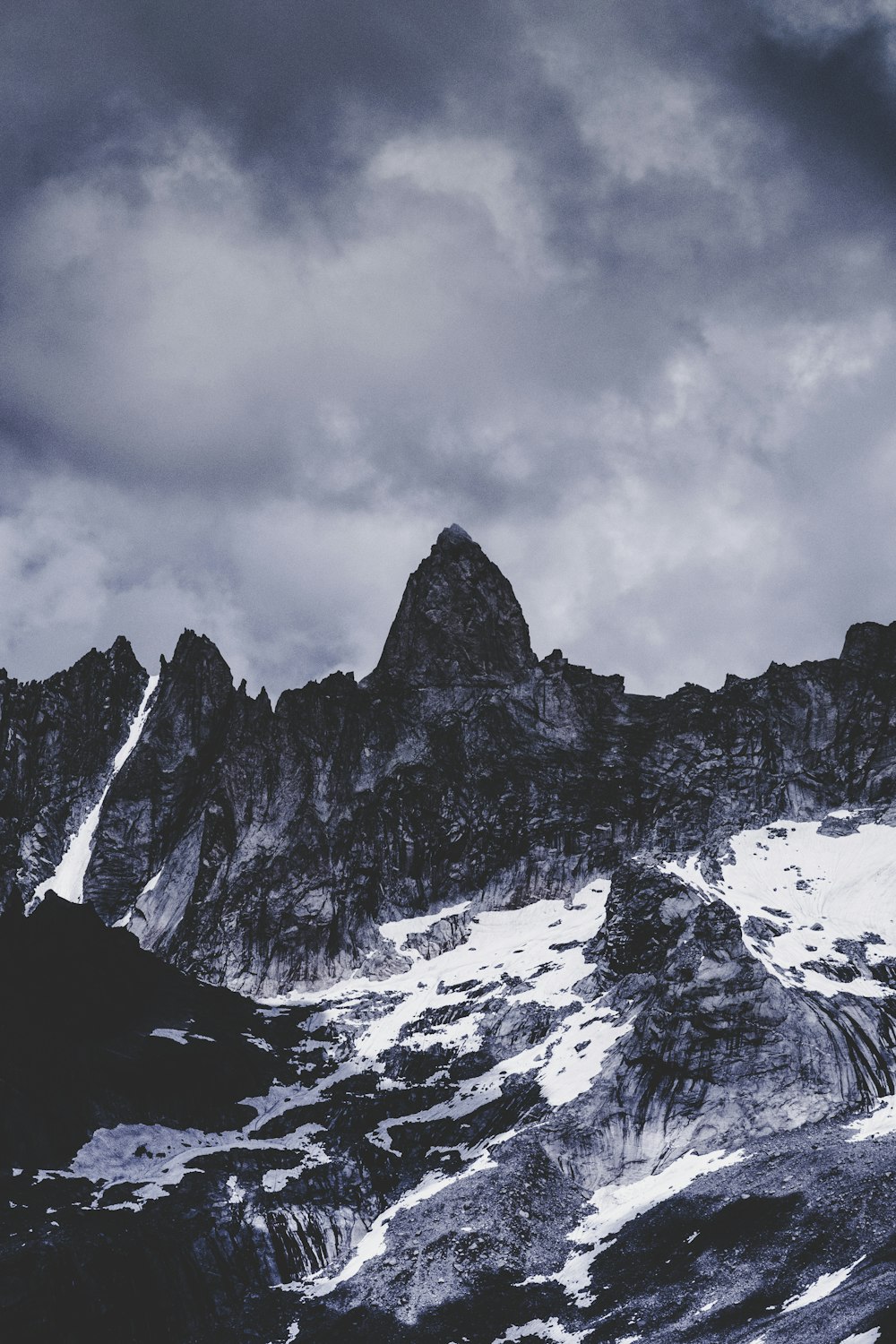 grayscale landscape photography of mountain under alto cumulus clouds