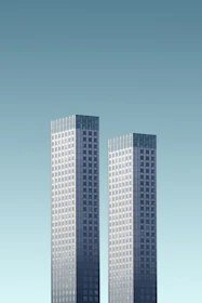two teal-and-white skyscrapers