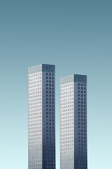 two teal-and-white skyscrapers