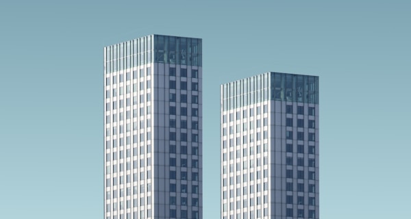 two teal-and-white skyscrapers