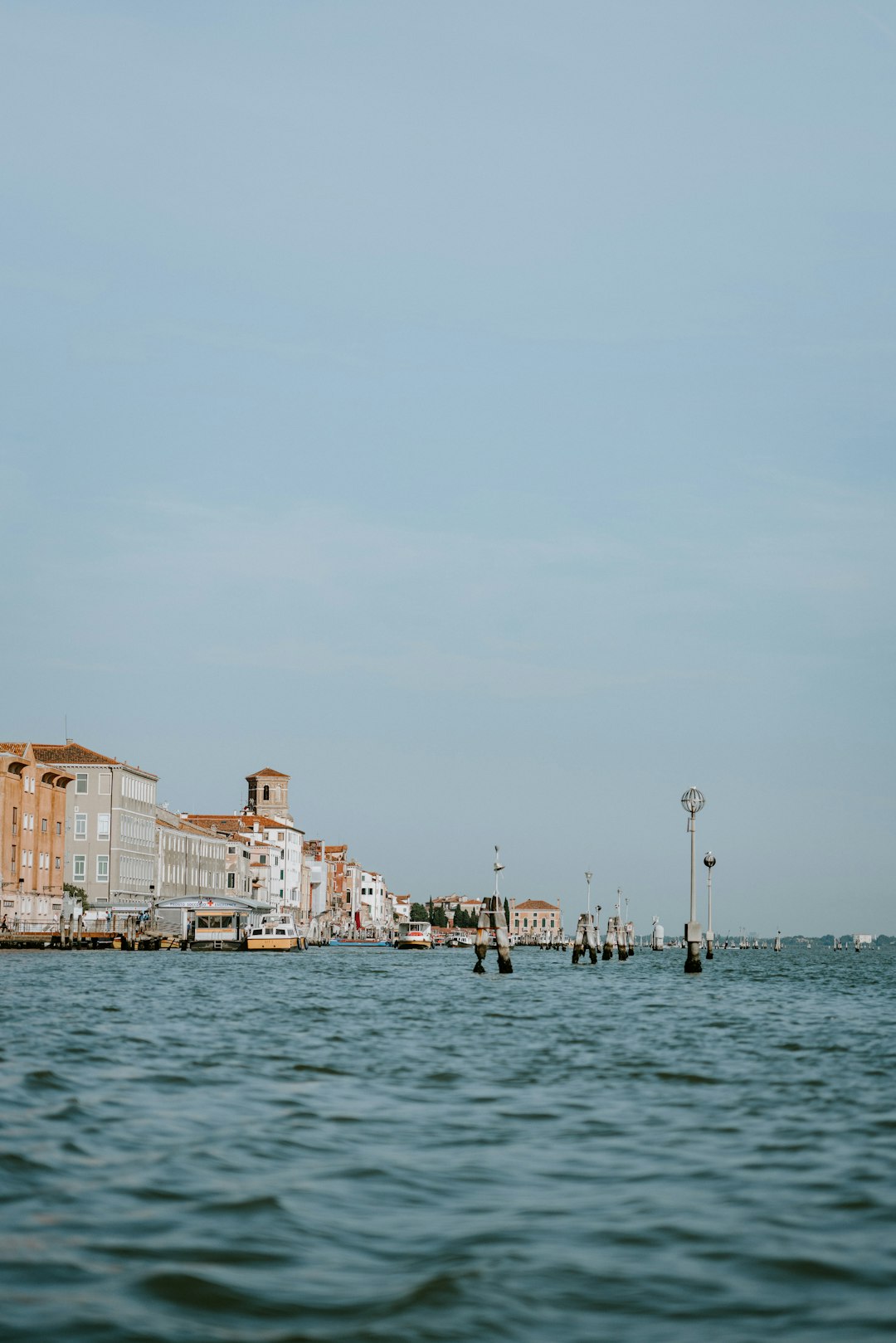 body of water beside white and brown concrete buildings