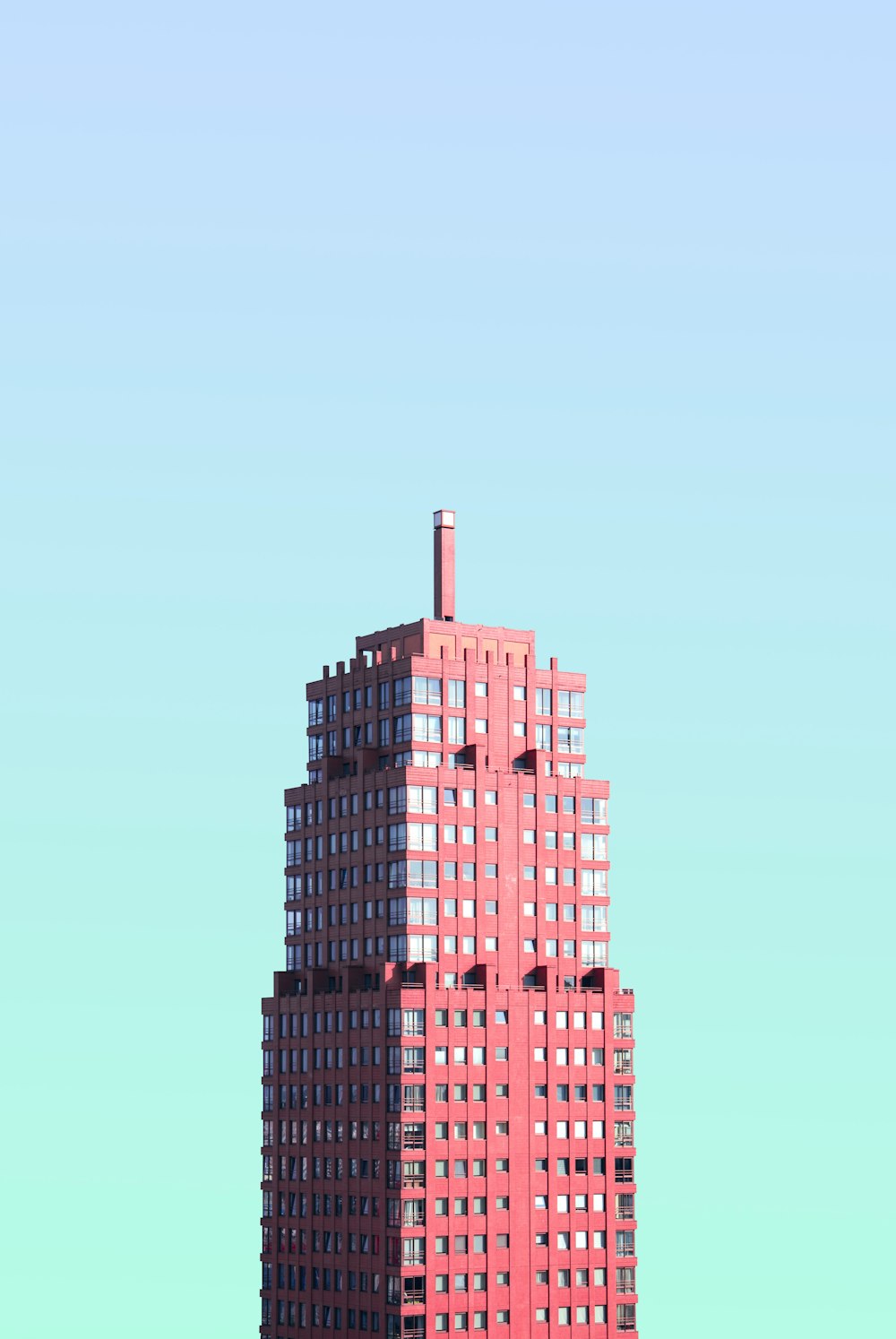 red high-rise building under blue sky