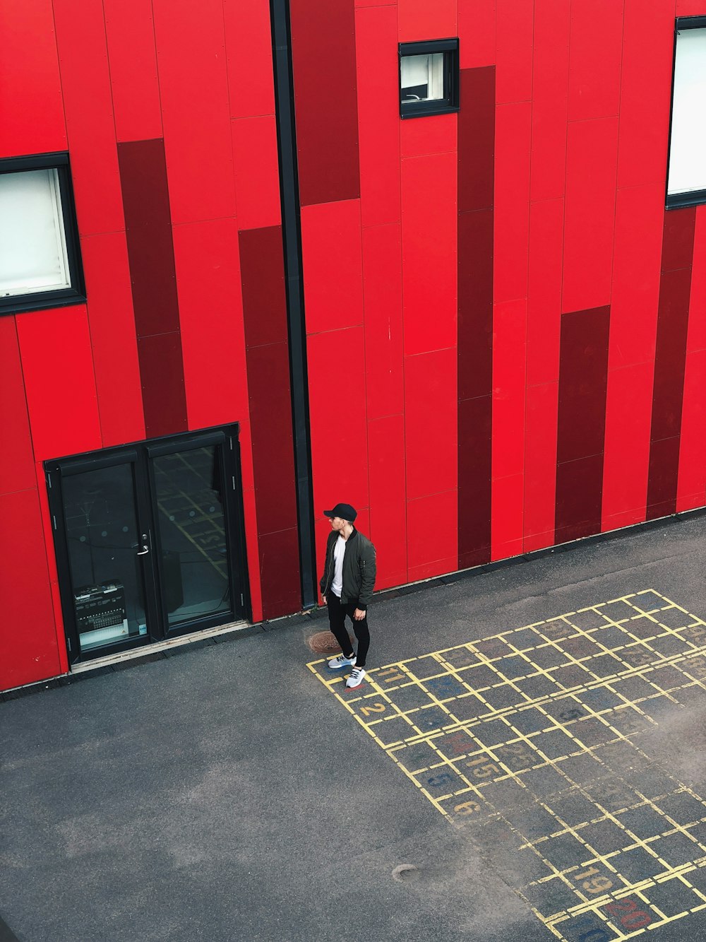 man standing near full-glass door