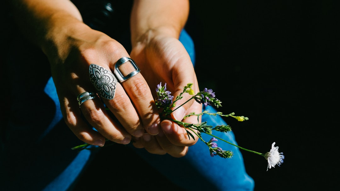 person holding white flowering plant