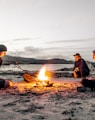 three men in front of bonfire