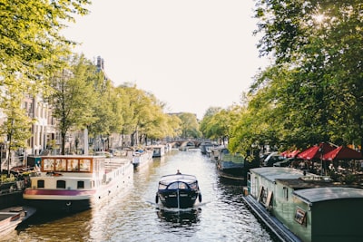 boat on river during daytime netherlands teams background