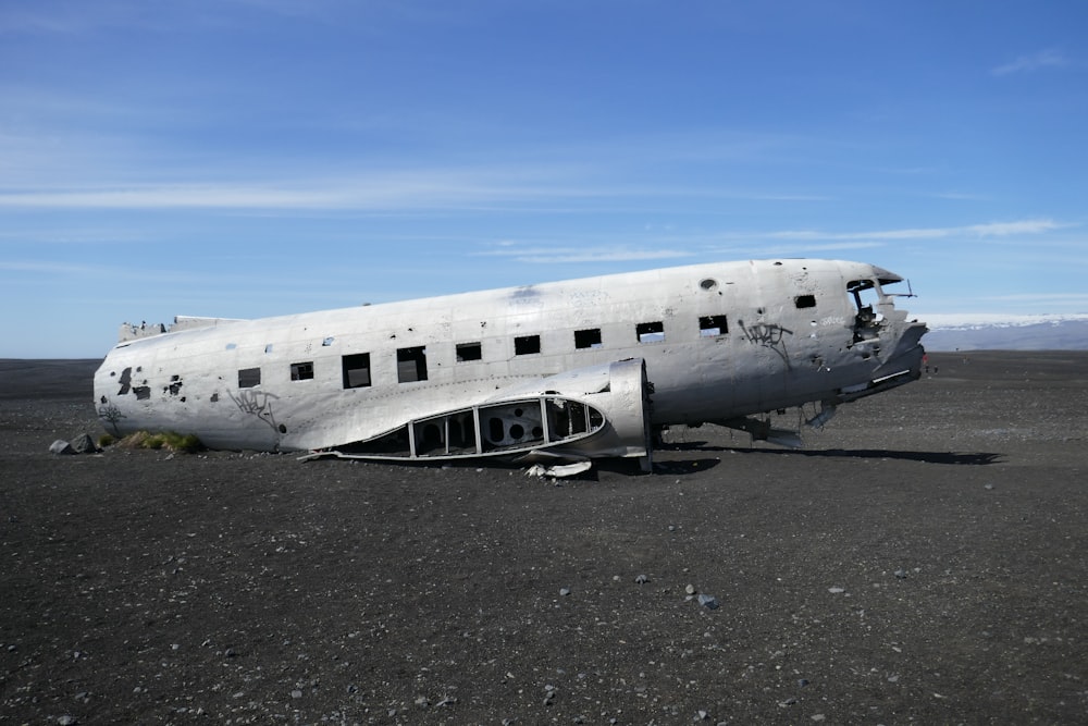 wrecked white plane on gray gravel