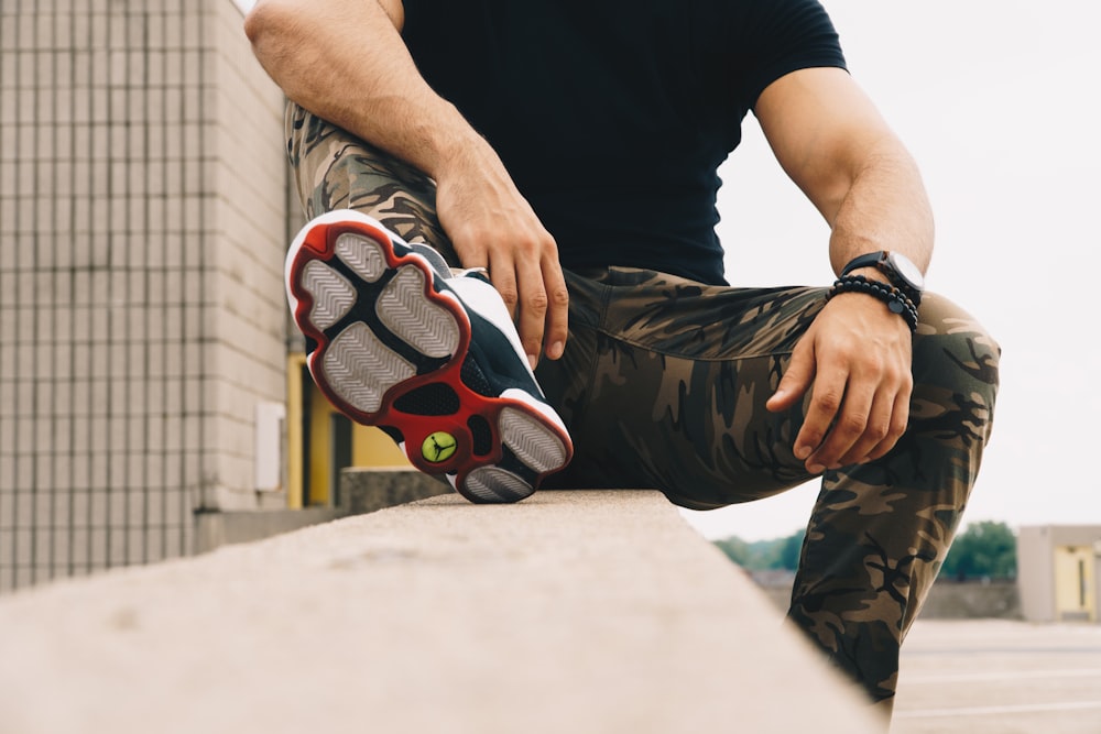 man in black shirt and brown camouflage pants