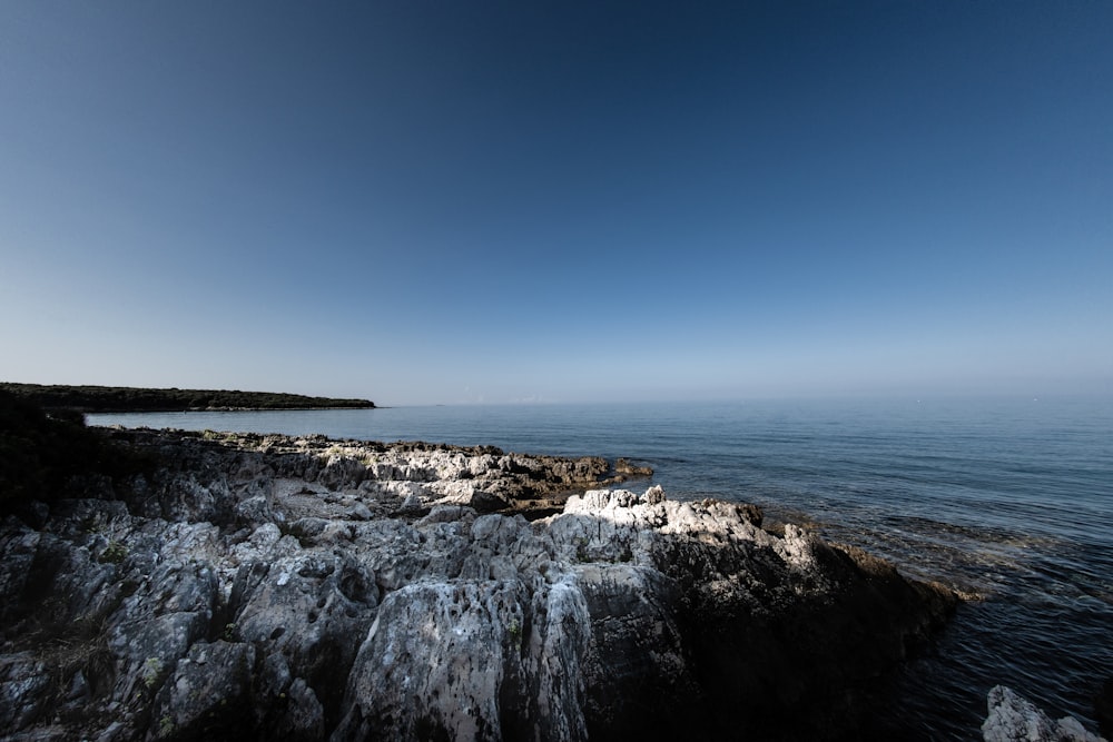 body of water under blue sky